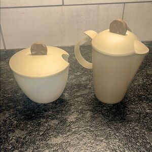 Vintage sugar and creamer by Tupperware. Look to be new. Flip lid on creamer